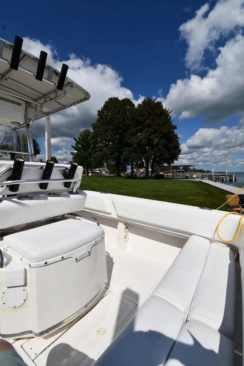 Slide: The Image of 2000 Fountain 31 Tournament Edition boat docked by a scenic lakeside. - 19