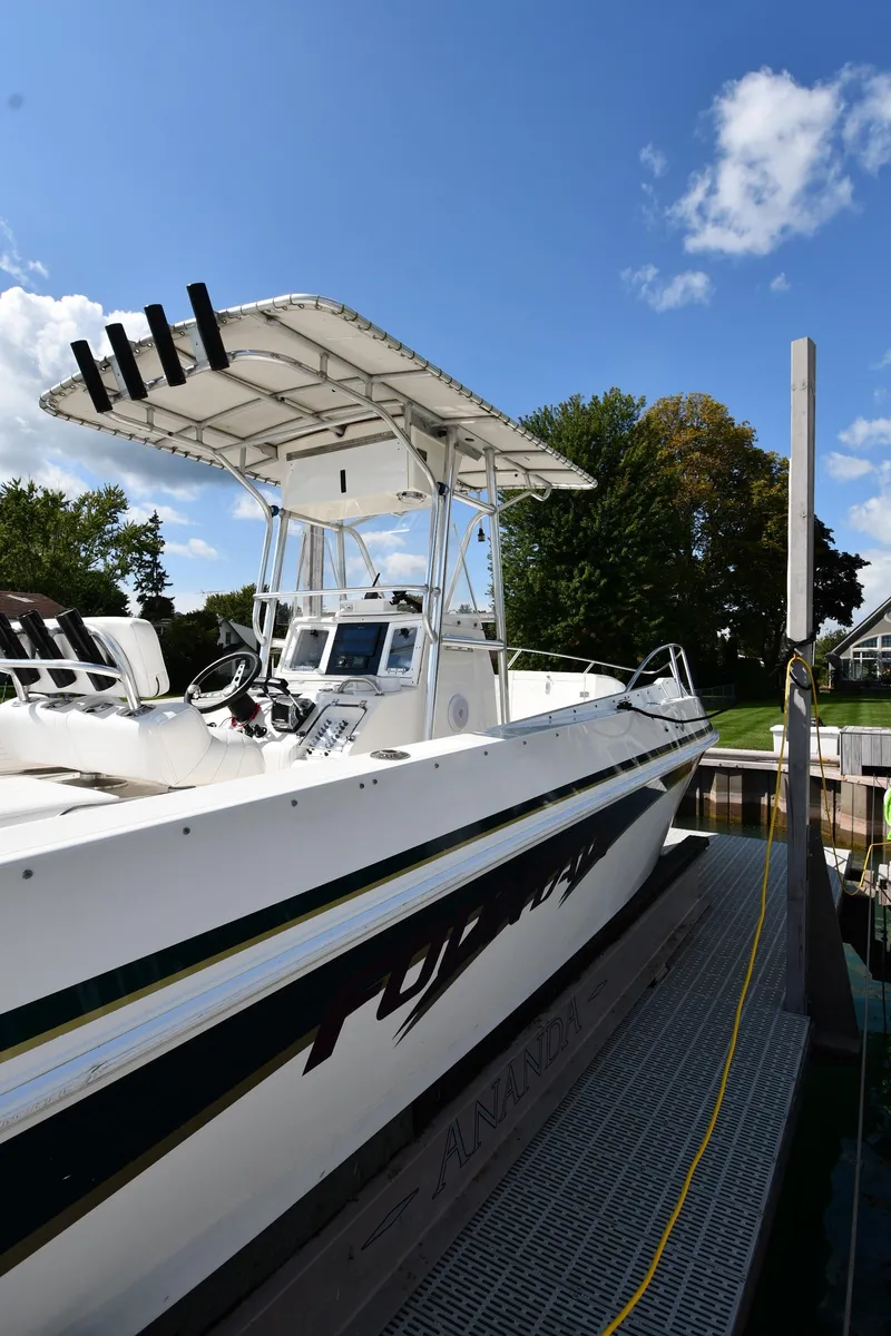 Slide: The Image of 2000 Fountain 31 Tournament Edition boat docked under a clear blue sky. - 2
