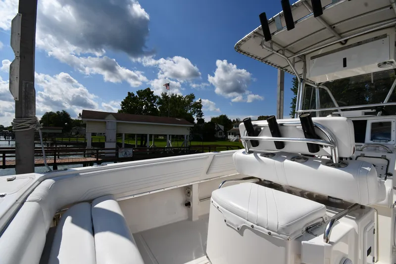 Slide: The Image of 2000 Fountain 31 Tournament Edition boat docked under a partly cloudy sky. - 20