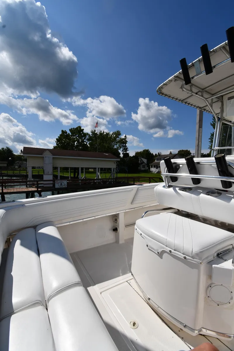 Slide: The Image of 2000 Fountain 31 Tournament Edition boat with white seating under a clear blue sky. - 21