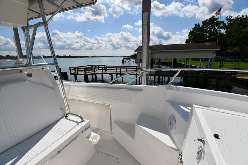 Slide: The Image of 2000 Fountain 31 Tournament Edition boat docked by a scenic waterfront with clear skies. - 30