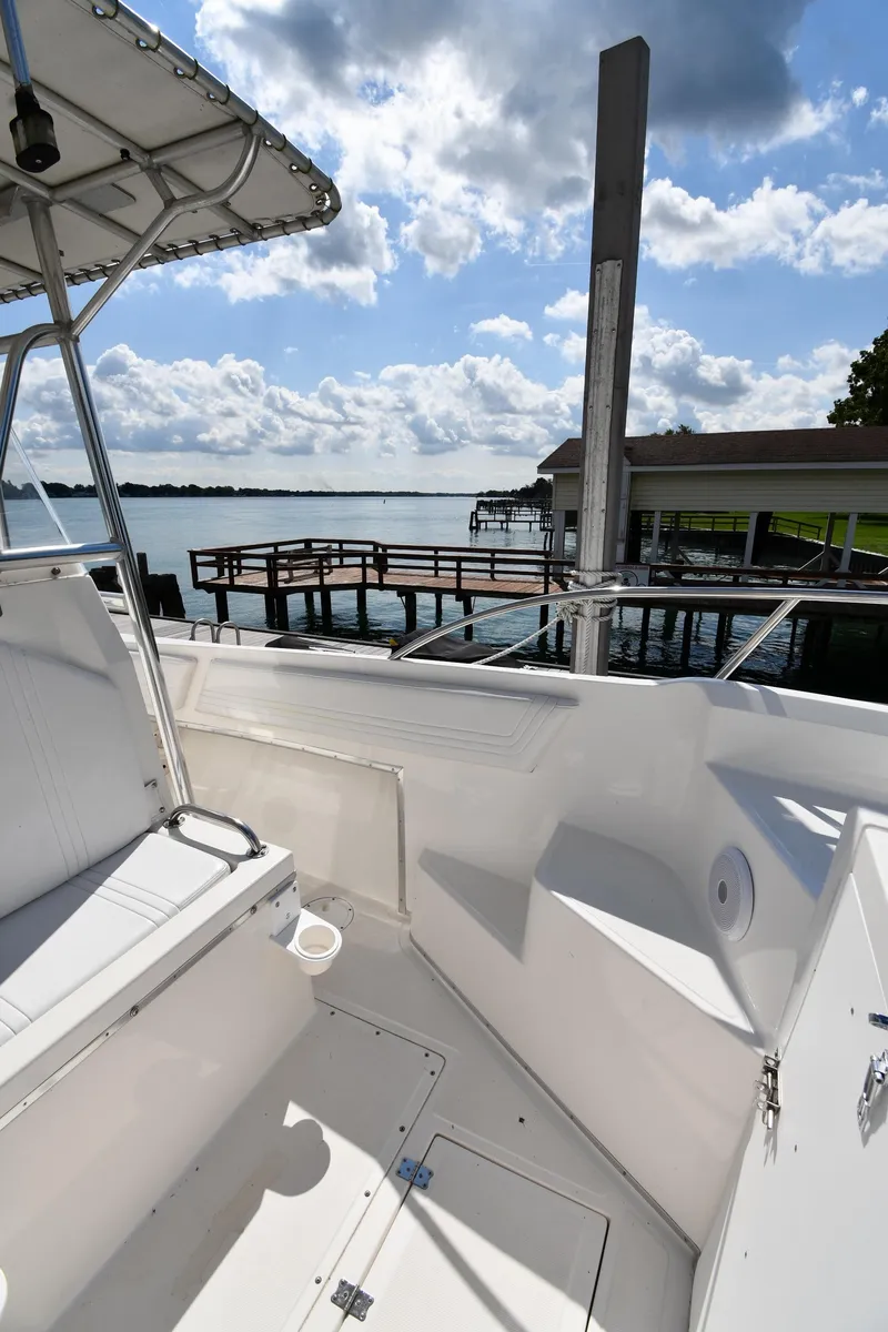 Slide: The Image of 2000 Fountain 31 Tournament Edition boat docked by a scenic waterfront. - 31