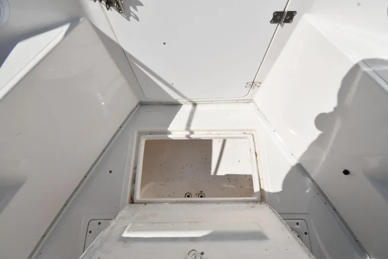 Slide: The Image of 2000 Fountain 31 Tournament Edition boat interior with open storage compartment. - 34