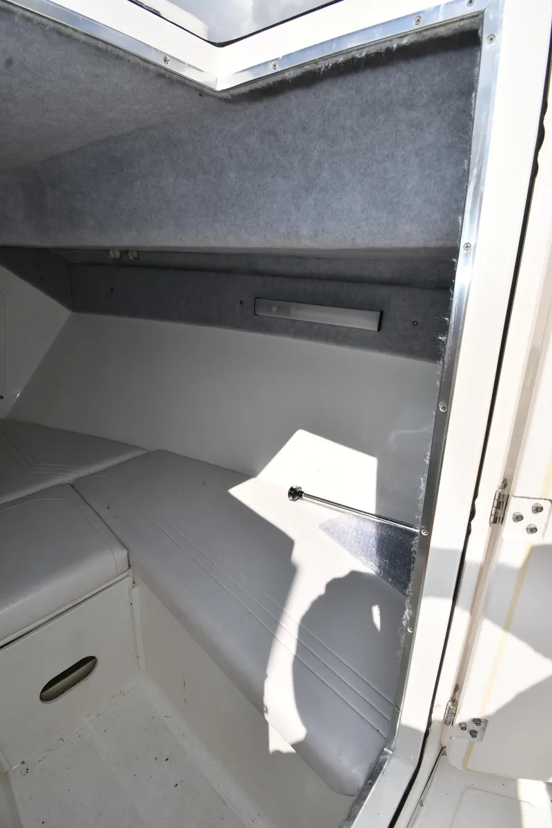 Slide: The Image of 2000 Fountain 31 Tournament Edition cabin interior with cushioned seating. - 41