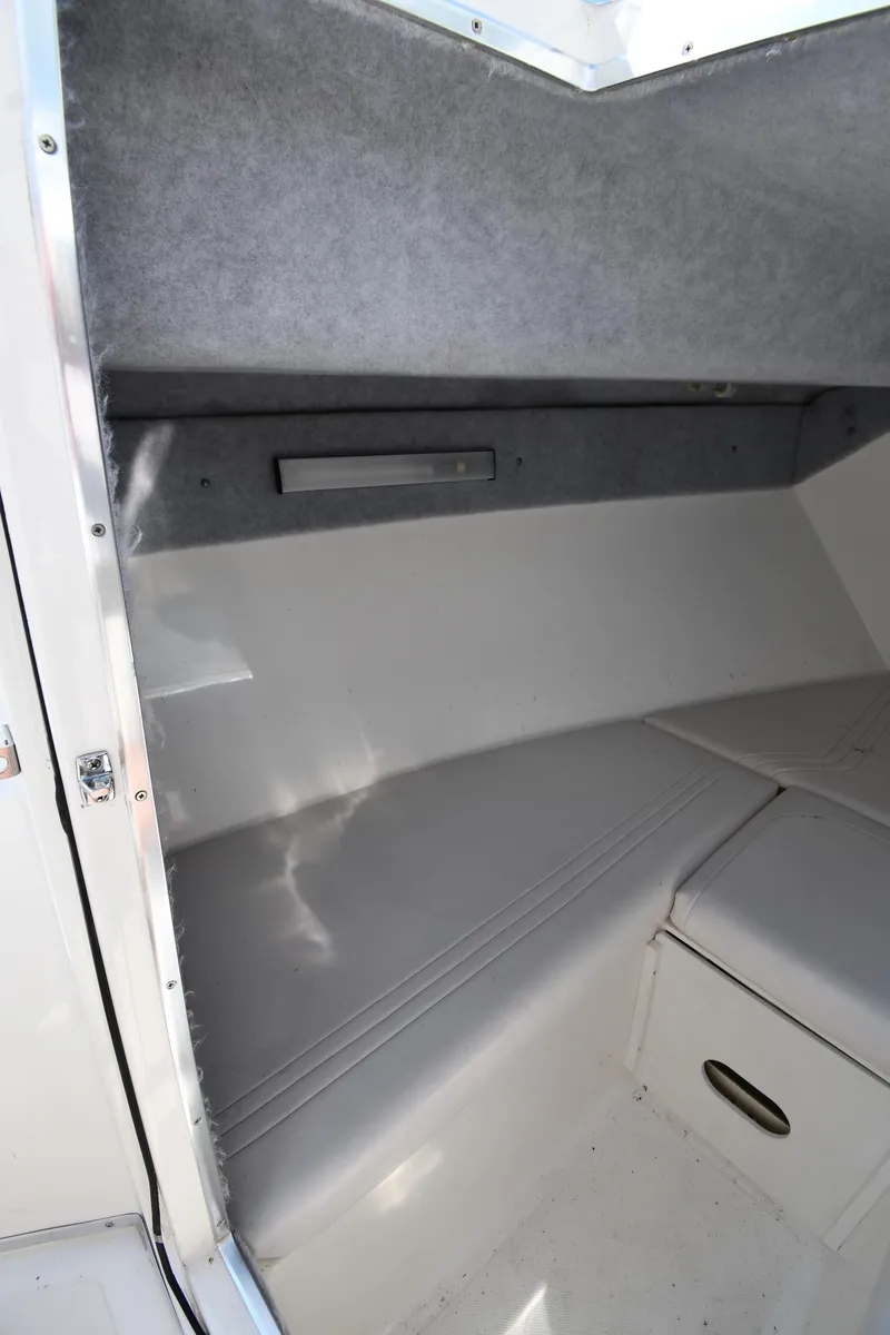 Slide: The Image of 2000 Fountain 31 Tournament Edition boat interior cabin with cushioned seating. - 42