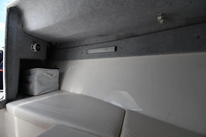 Slide: The Image of 2000 Fountain 31 Tournament Edition boat interior with cushioned seating and storage. - 43