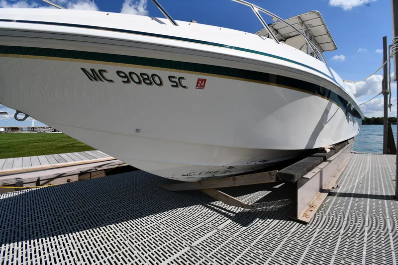 Slide: The Image of 2000 Fountain 31 Tournament Edition boat on dock under clear sky. - 47