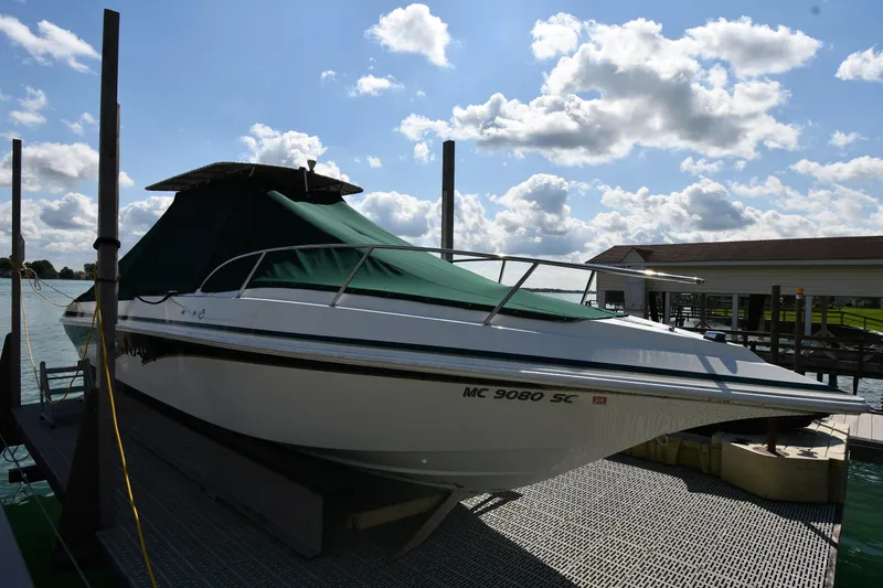 Slide: The Image of 2000 Fountain 31 Tournament Edition boat docked under a cloudy sky. - 48