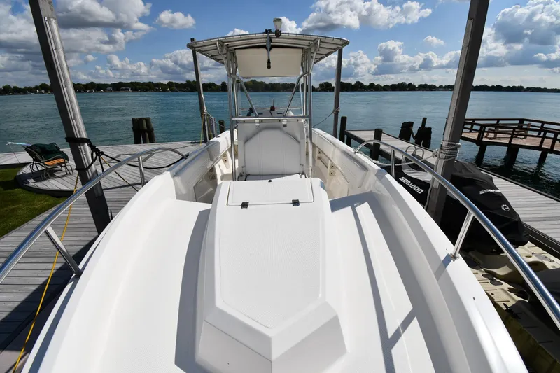 Slide: The Image of 2000 Fountain 31 Tournament Edition boat docked by a serene lake under a cloudy sky. - 6