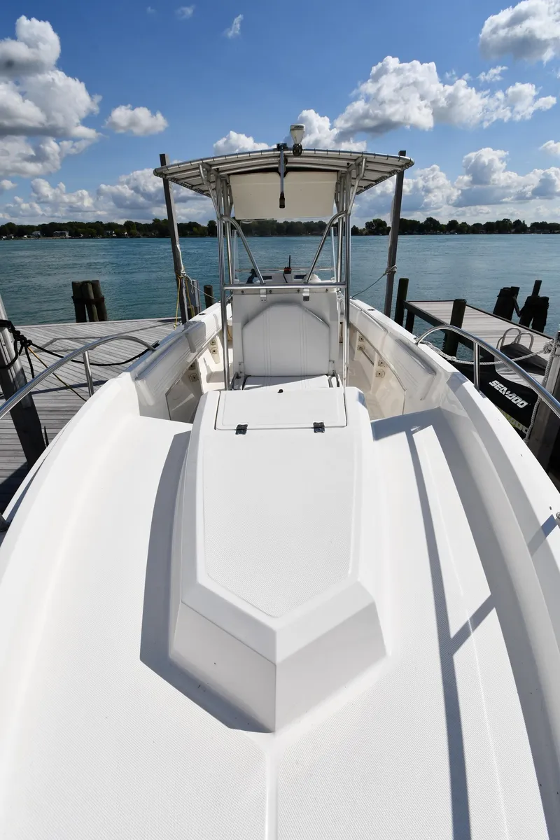 Slide: The Image of 2000 Fountain 31 Tournament Edition boat docked by a scenic lake under a blue sky. - 7