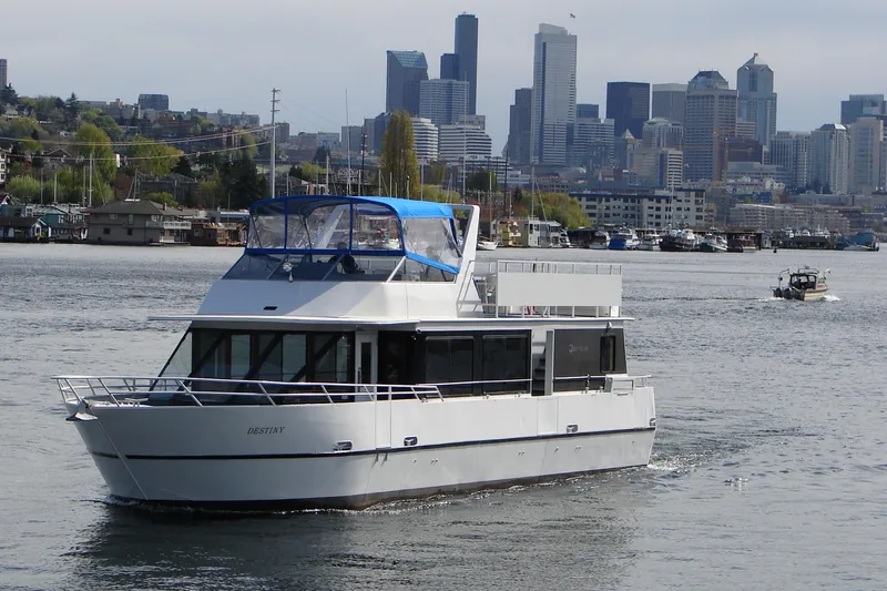The Image of 1993 Skipperliner 49 Passenger Yacht cruising with city skyline in background. - 0