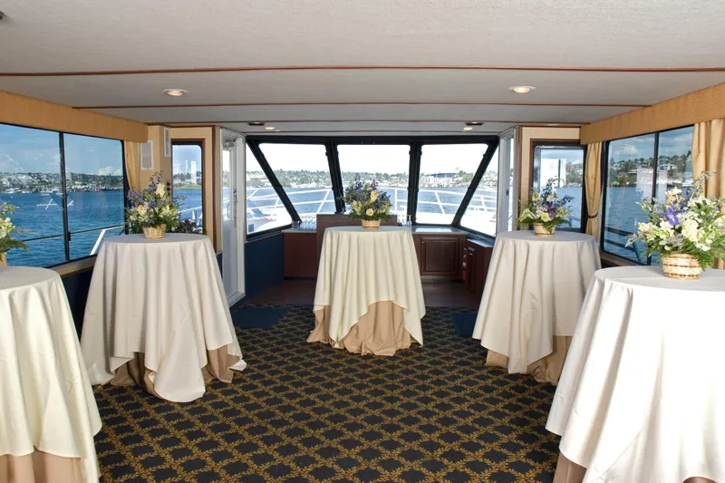 Slide: The Image of Luxurious interior of 1993 Skipperliner 49 Passenger Yacht with elegant table settings. - 2