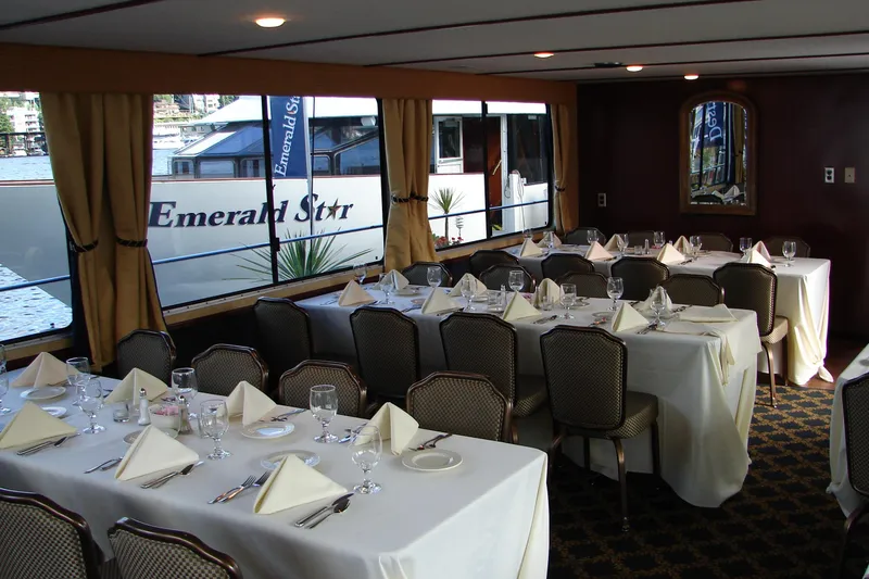 Slide: The Image of Elegant dining area inside 1993 Skipperliner 49 Passenger Yacht, featuring set tables and large windows. - 4