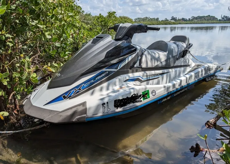 Slide: The Image of 2019 Yamaha WaveRunner VX Cruiser jet ski docked by lush greenery. - 6