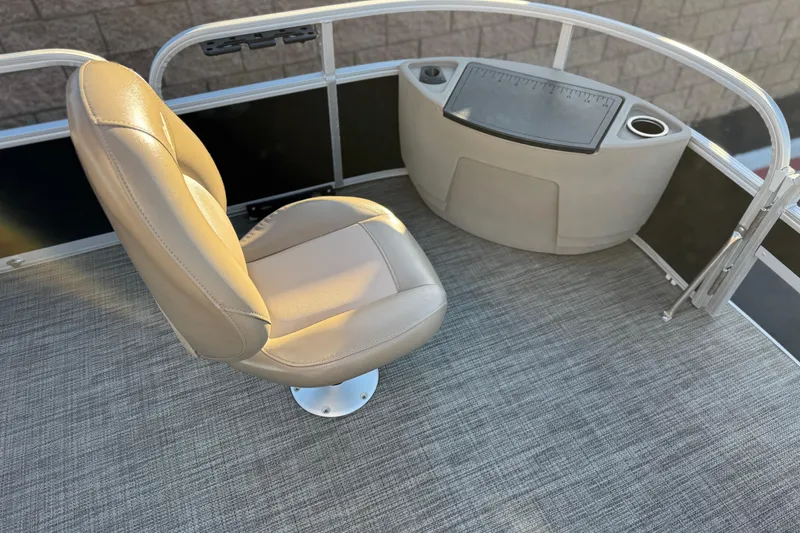Slide: The Image of 2023 Ranger Reata 200F boat interior with beige seat and control panel. - 11