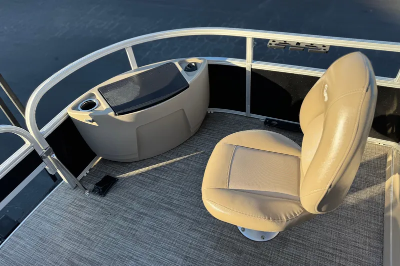 Slide: The Image of 2023 Ranger Reata 200F boat interior with beige seating and console. - 12