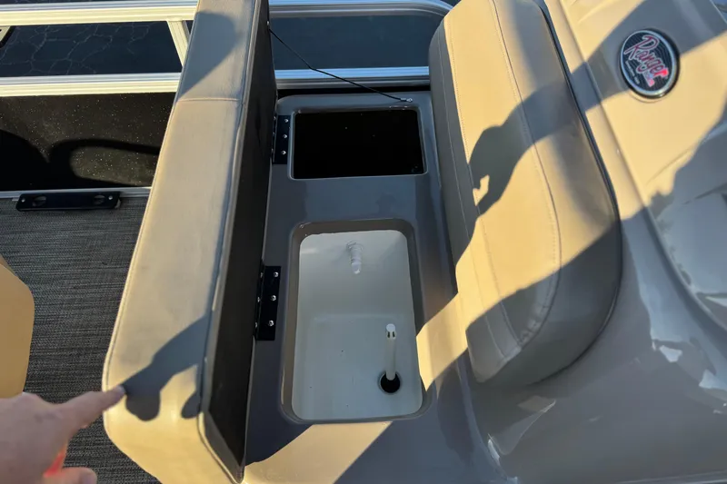 Slide: The Image of 2023 Ranger Reata 200F boat interior with storage compartments and seating. - 16