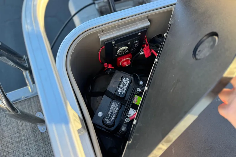 Slide: The Image of Battery compartment of 2023 Ranger Reata 200F boat, showing wiring and connections. - 21
