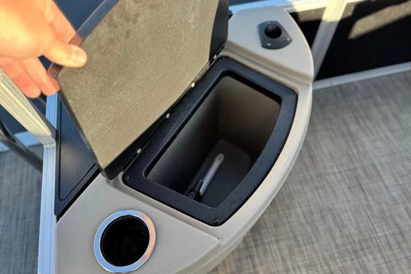 Slide: The Image of 2023 Ranger Reata 200F storage compartment with cup holder, open lid view. - 22