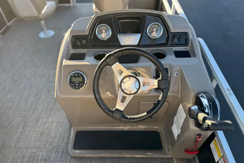 Slide: The Image of 2023 Ranger Reata 200F boat dashboard with steering wheel and controls. - 26