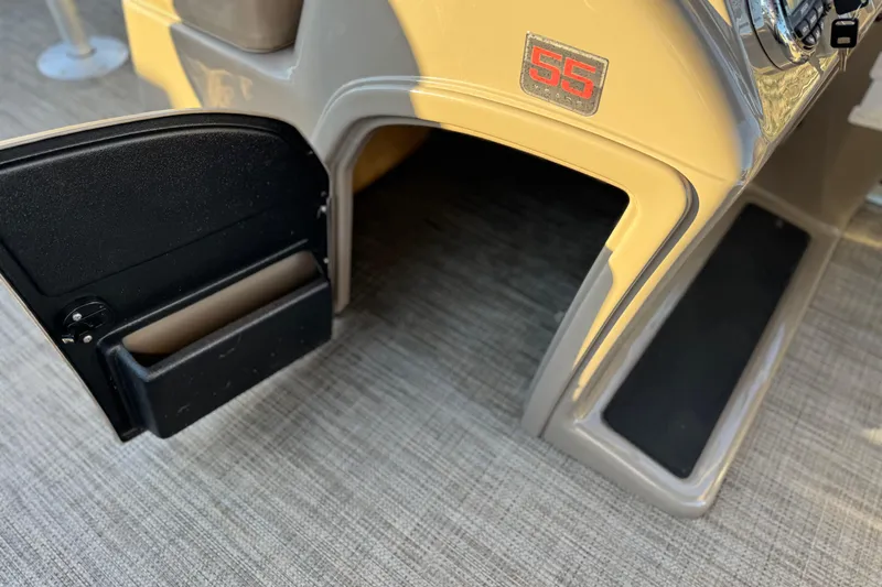 Slide: The Image of 2023 Ranger Reata 200F boat console with open storage compartment. - 27