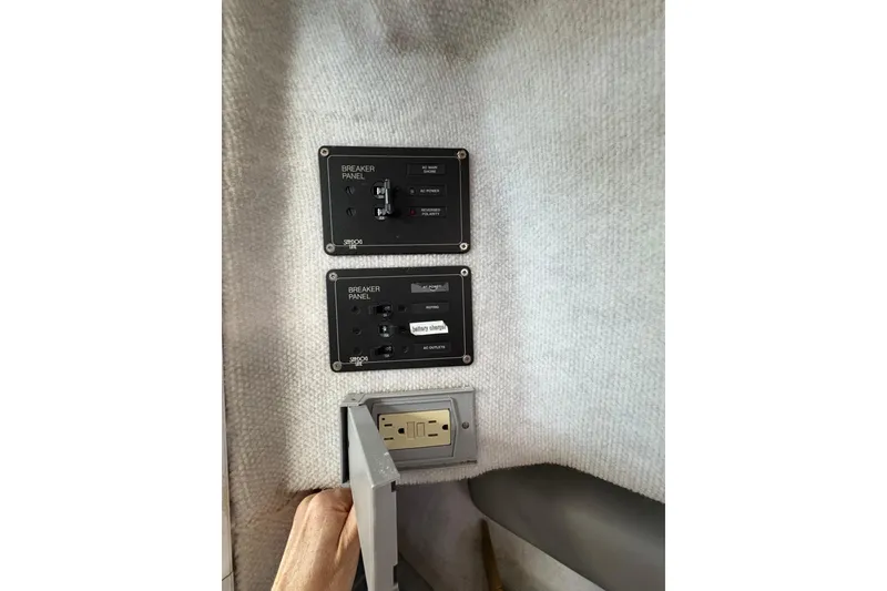 Slide: The Image of Breaker panels and outlet on 2001 Glacier Bay 2690 Coastal Runner boat interior. - 23