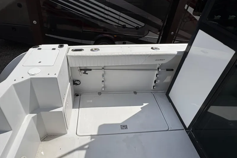 Slide: The Image of 2001 Glacier Bay 2690 Coastal Runner boat interior with seating and storage compartments. - 30