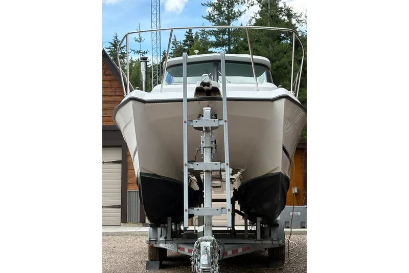 Slide: The Image of 2001 Glacier Bay 2690 Coastal Runner boat on trailer, parked outdoors. - 40