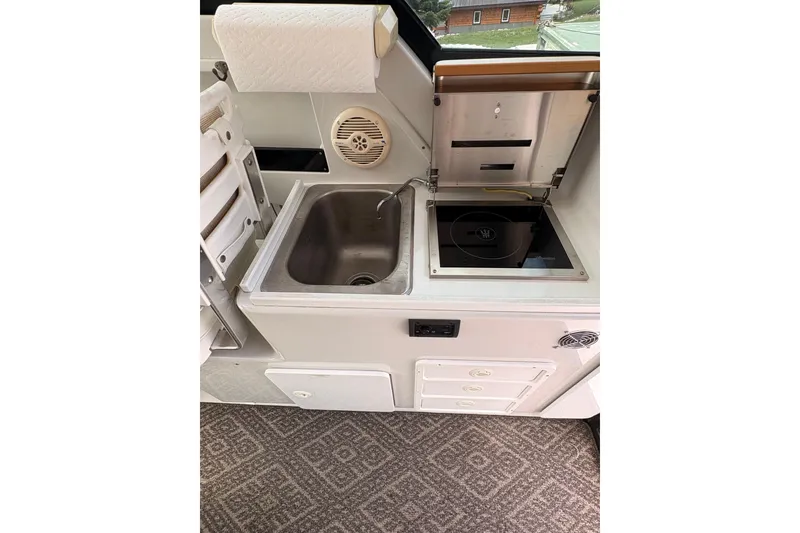 Slide: The Image of 2001 Glacier Bay 2690 Coastal Runner boat kitchen with sink and stove. - 5