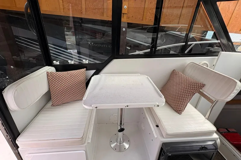 Slide: The Image of 2001 Glacier Bay 2690 Coastal Runner interior with seating and table. - 6