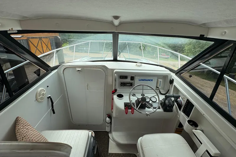 Slide: The Image of Interior view of 2001 Glacier Bay 2690 Coastal Runner boat cockpit with steering wheel and controls. - 7