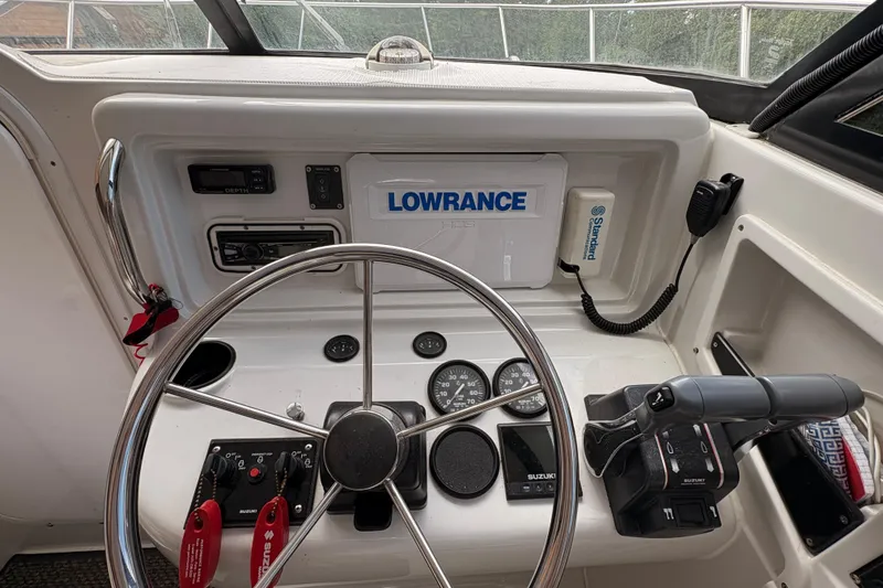 Slide: The Image of 2001 Glacier Bay 2690 Coastal Runner boat dashboard with steering wheel and navigation equipment. - 8