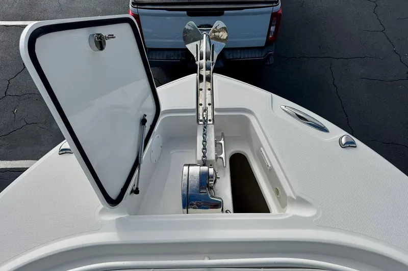 Slide: The Image of Open anchor compartment on 2014 Edgewater 280CC boat, showing anchor and chain mechanism. - 12