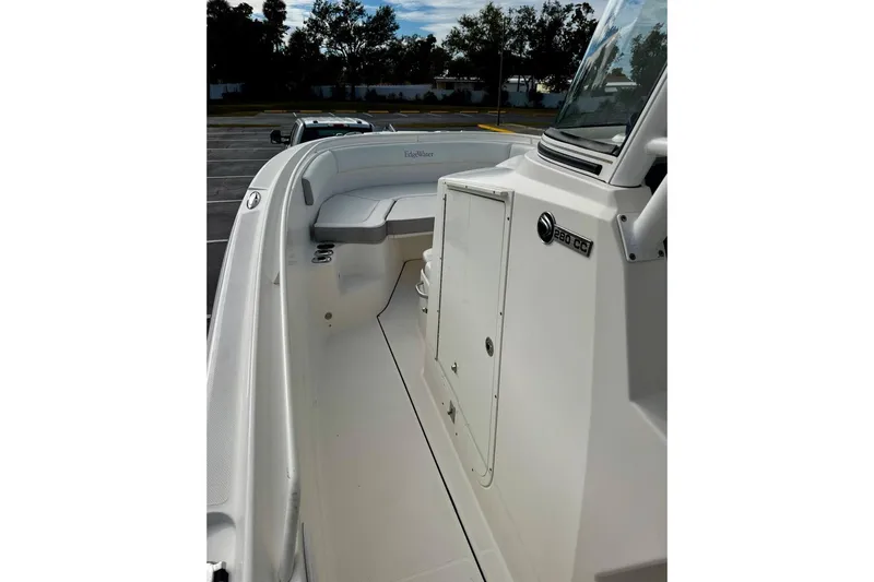 Slide: The Image of 2014 Edgewater 280CC boat interior with seating and console details. - 14