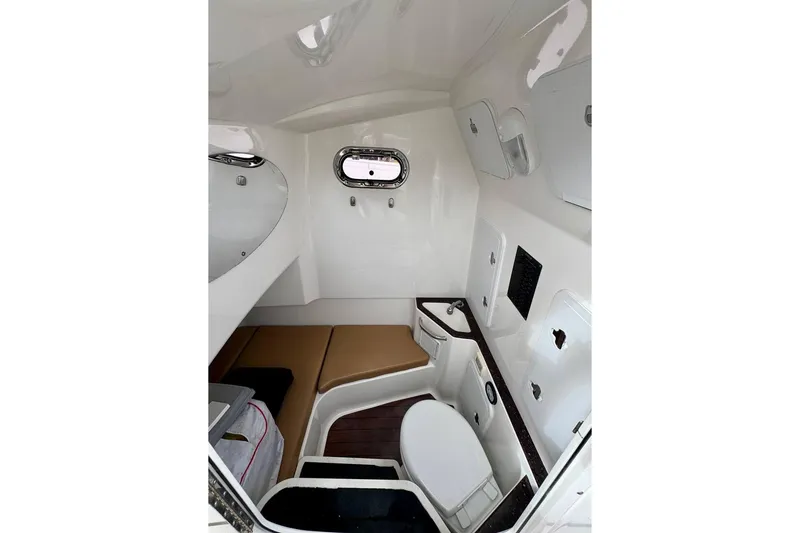 Slide: The Image of Interior cabin of 2014 Edgewater 280CC boat with seating and storage compartments. - 15