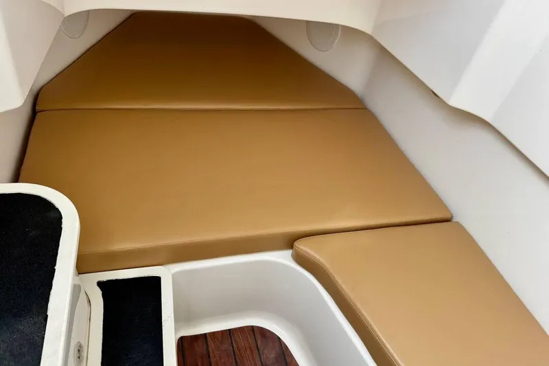 Slide: The Image of Interior cabin of 2014 Edgewater 280CC boat with tan cushions. - 17