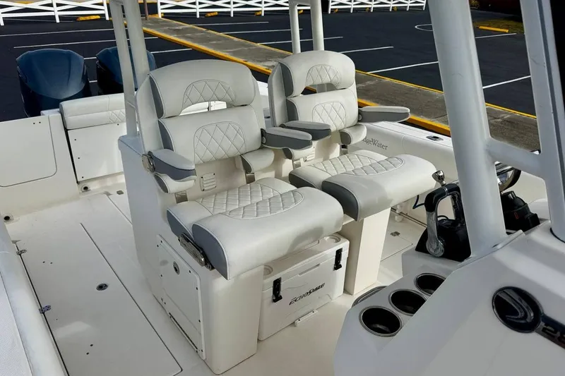 Slide: The Image of 2014 Edgewater 280CC boat interior with dual cushioned seats and control panel. - 20
