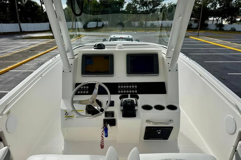Slide: The Image of 2014 Edgewater 280CC boat dashboard with steering wheel and navigation screens. - 21