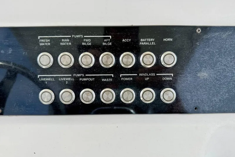 Slide: The Image of Control panel of a 2014 Edgewater 280CC boat with labeled buttons for various functions. - 27