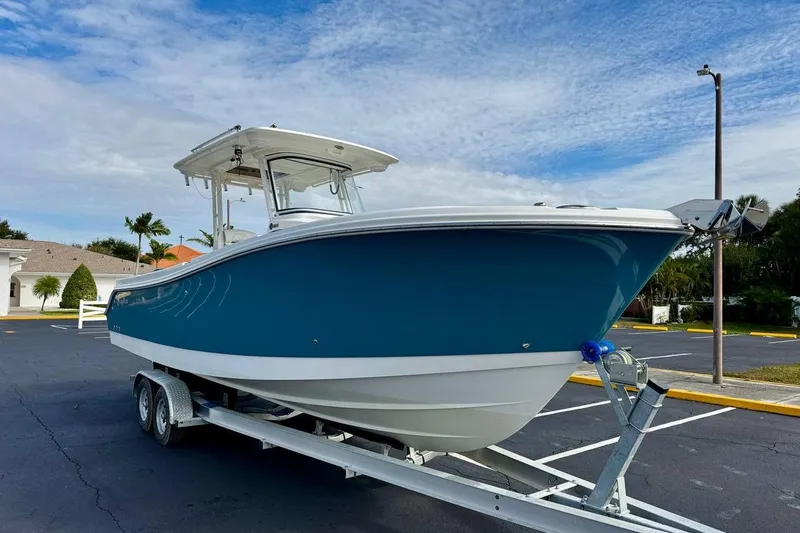 Slide: The Image of 2014 Edgewater 280CC boat on trailer, parked in a sunny lot. - 3