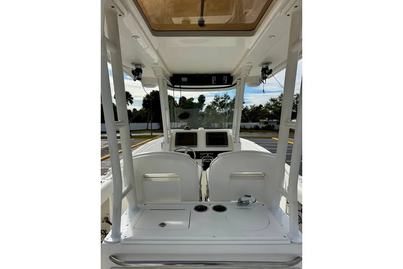 Slide: The Image of 2014 Edgewater 280CC boat interior with helm and seating area. - 31