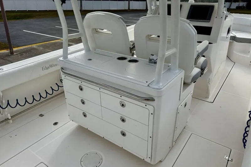 Slide: The Image of 2014 Edgewater 280CC boat interior with seating and storage compartments. - 33