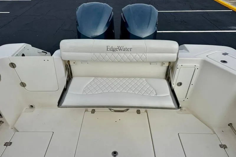 Slide: The Image of 2014 Edgewater 280CC boat with foldable white bench seat and dual engines. - 36