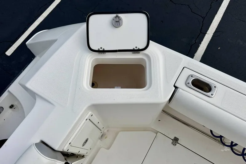 Slide: The Image of 2014 Edgewater 280CC boat storage compartment with open lid, showcasing interior space. - 37