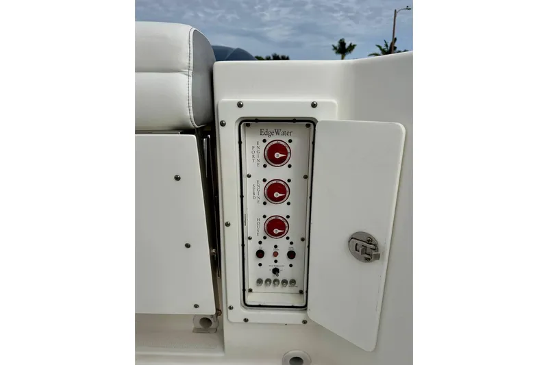 Slide: The Image of Control panel of a 2014 Edgewater 280CC boat with red switches and labels. - 38