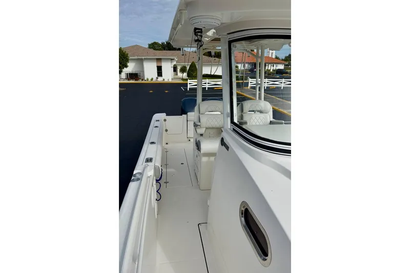 Slide: The Image of 2014 Edgewater 280CC boat interior with seating and console view. - 40
