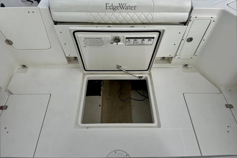 Slide: The Image of 2014 Edgewater 280CC boat storage compartment with open hatch and visible interior. - 43