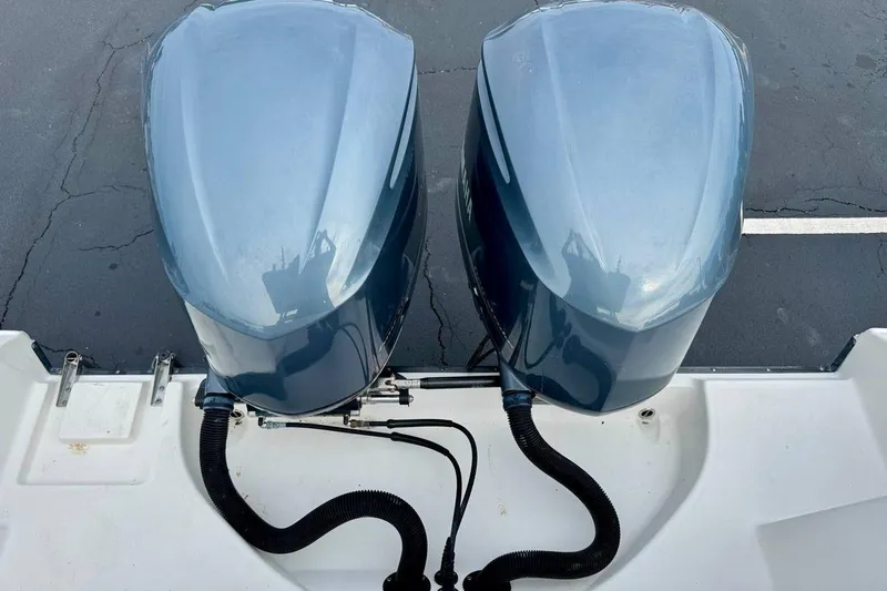 Slide: The Image of Twin outboard engines on a 2014 Edgewater 280CC boat, viewed from above. - 46