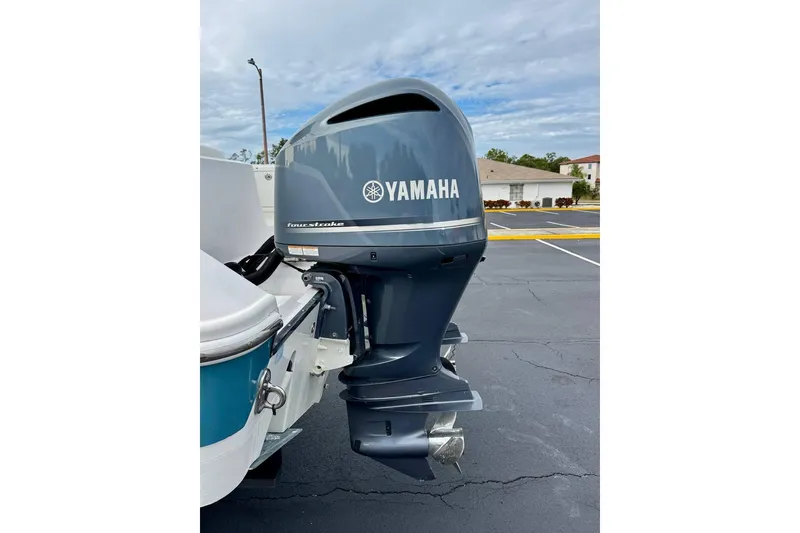 Slide: The Image of 2014 Edgewater 280CC boat with Yamaha four-stroke outboard motor in parking lot. - 48