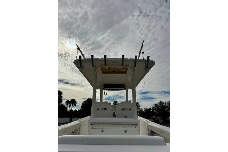 Slide: The Image of 2014 Edgewater 280CC boat with T-top under cloudy sky. - 52